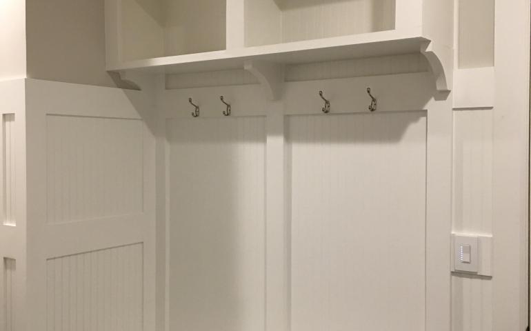 Beadboard and batten seam arrival center and hallway millwork project by TCS.