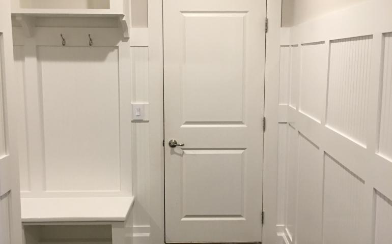 Beadboard and batten seam arrival center and hallway millwork project by TCS.