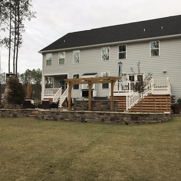 House with retaining walls, fire pit, outdoor kitchen, etc.